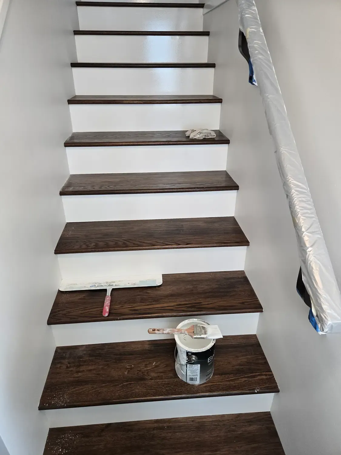 Staircase with white risers painted between dark wood treads