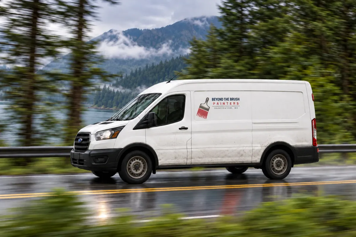 A plain white work van with a small Beyond The Brush sticker
