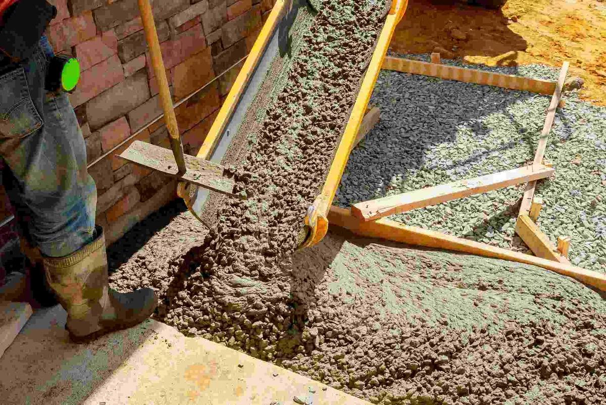Worker spreading concrete