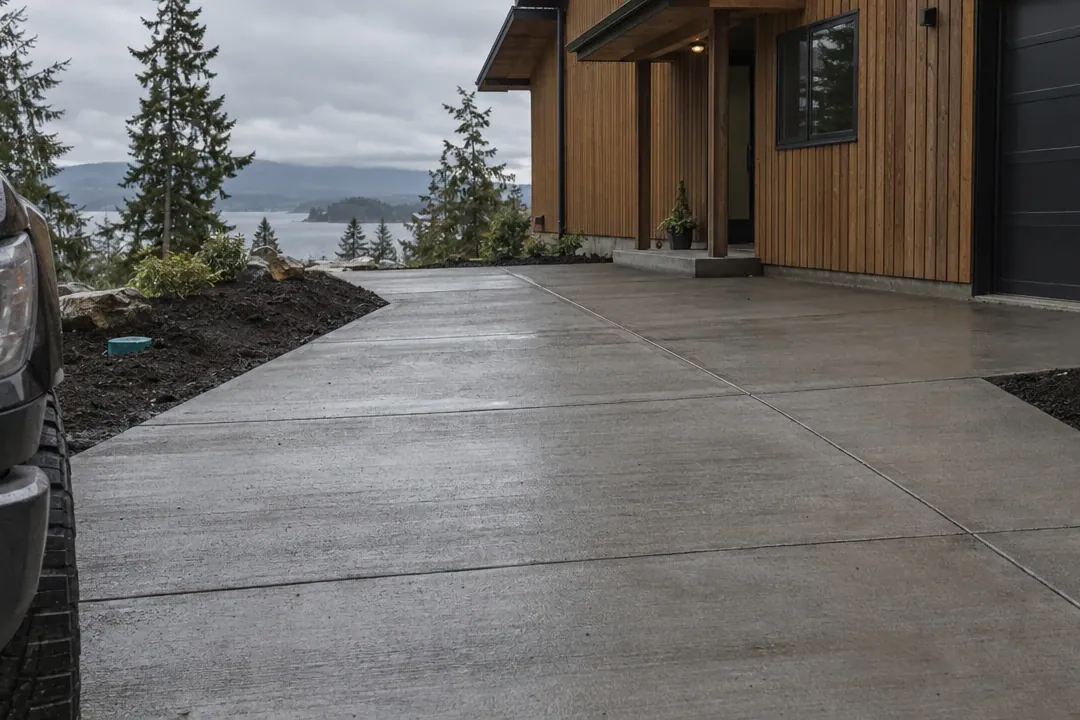 New concrete driveway at a lakeside home