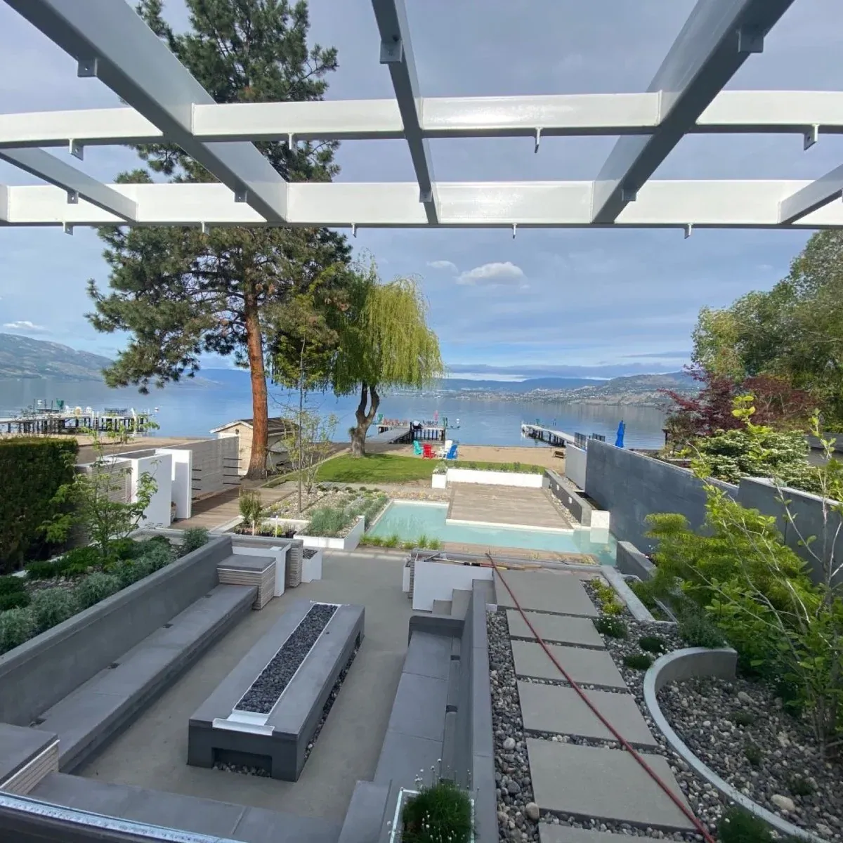 A KCC concrete patio with a fire table and lake views