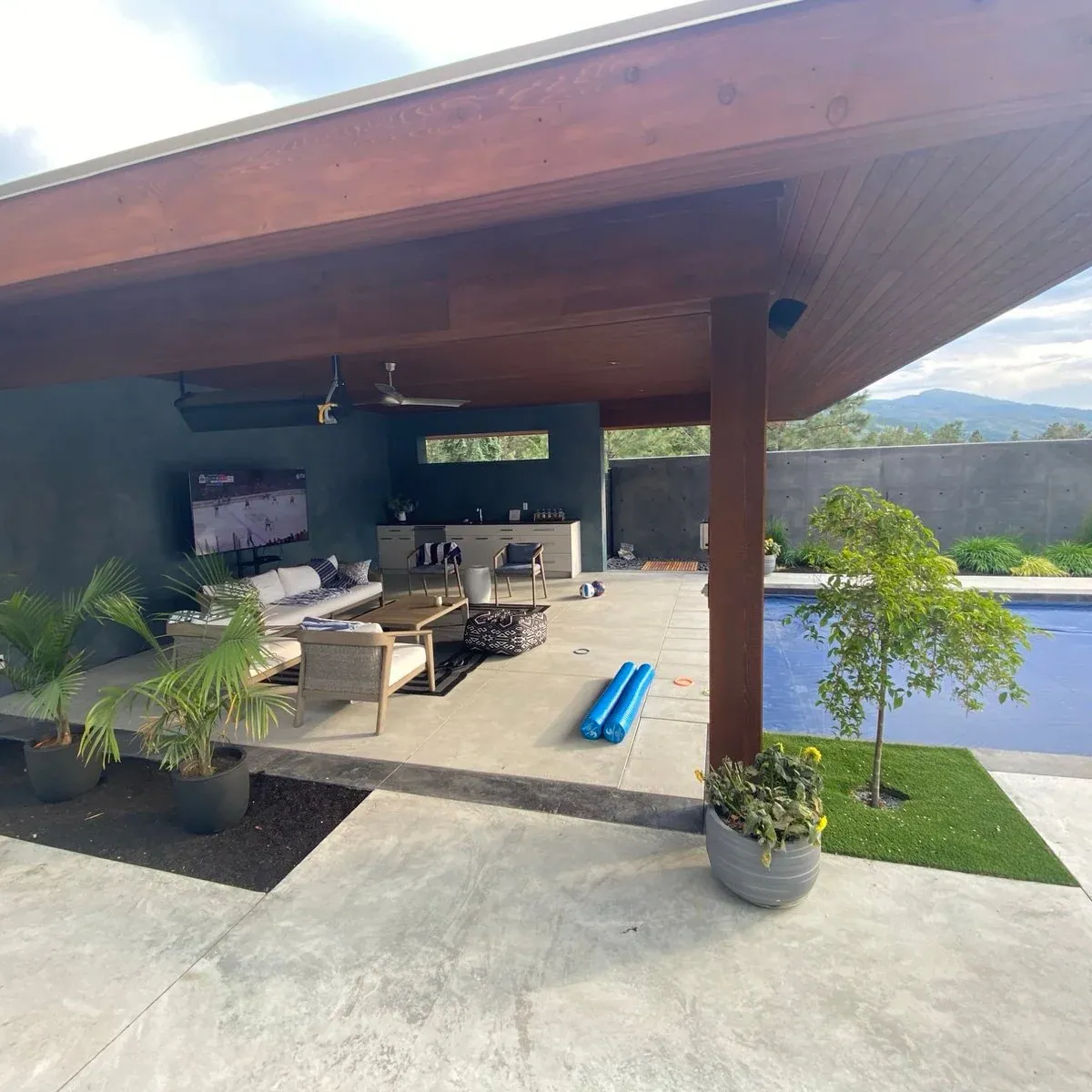 A KCC covered outdoor living space with a cedar ceiling