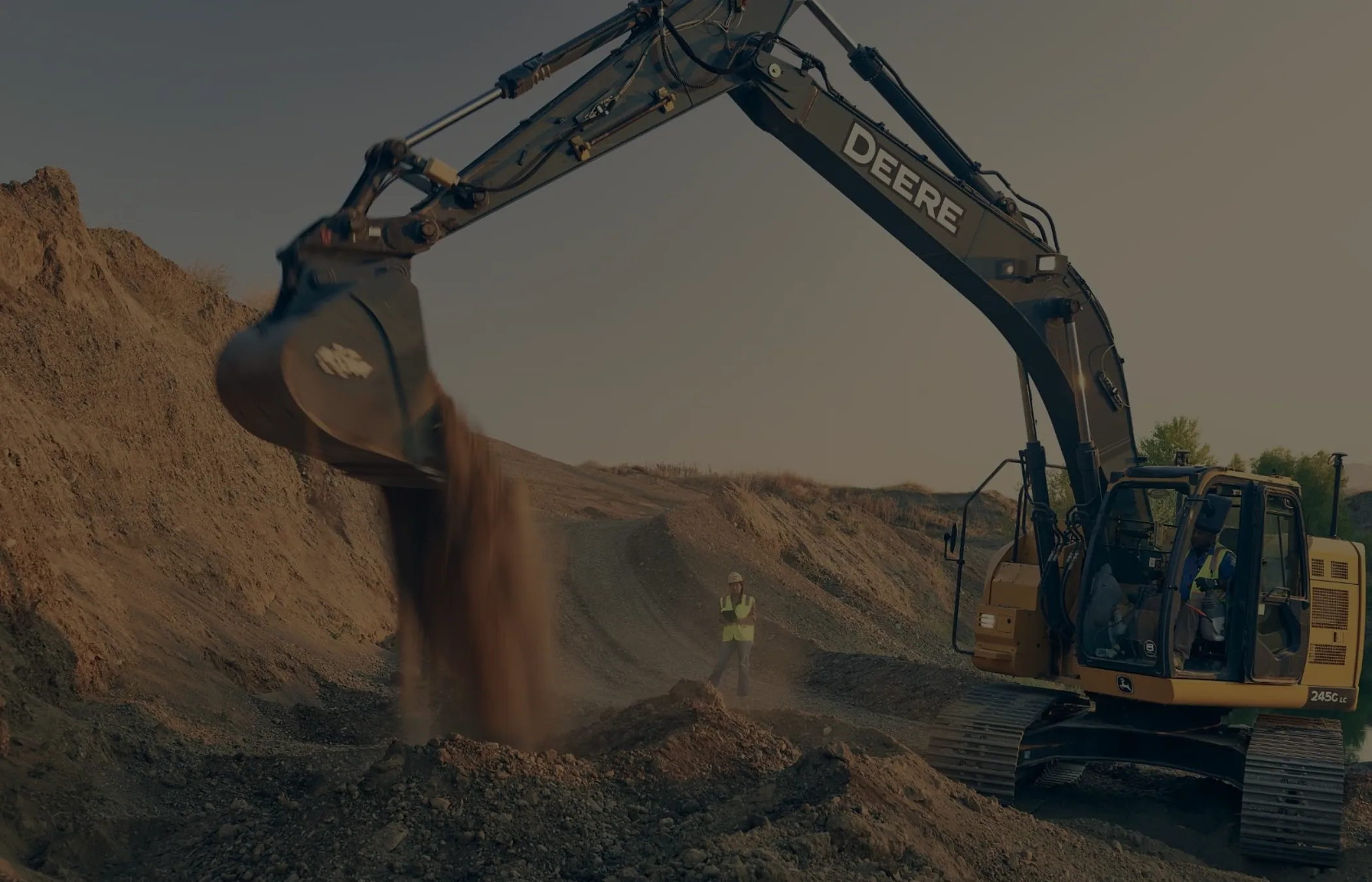 A John Deere excavator working on a construction site