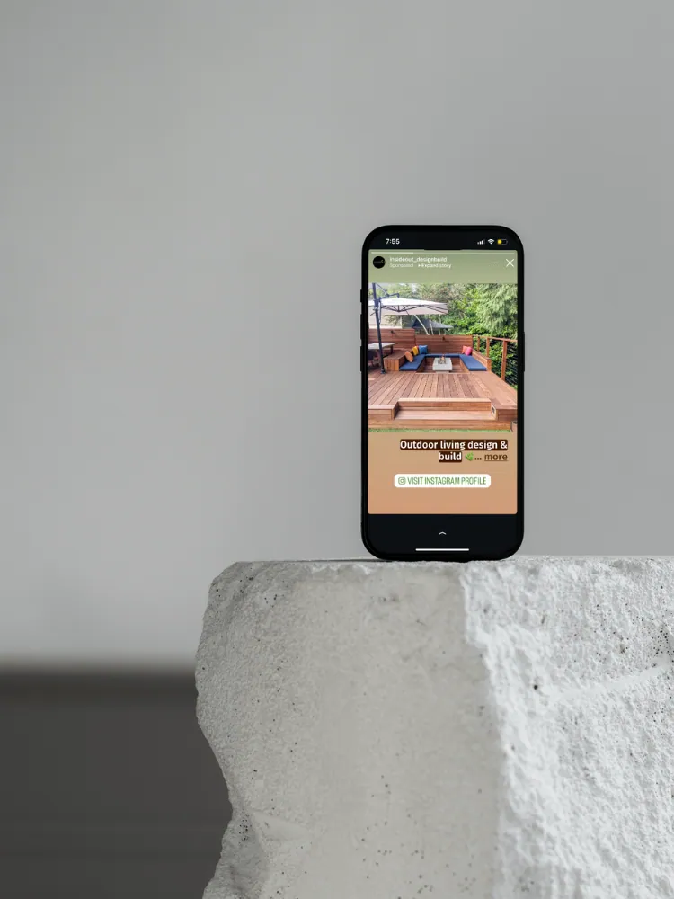 Phone showing an outdoor living company ad on Instagram