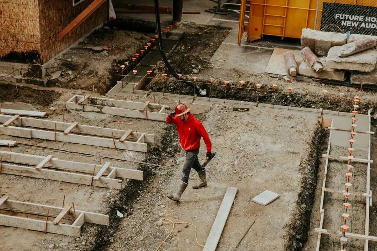 Worker walking across concrete forms