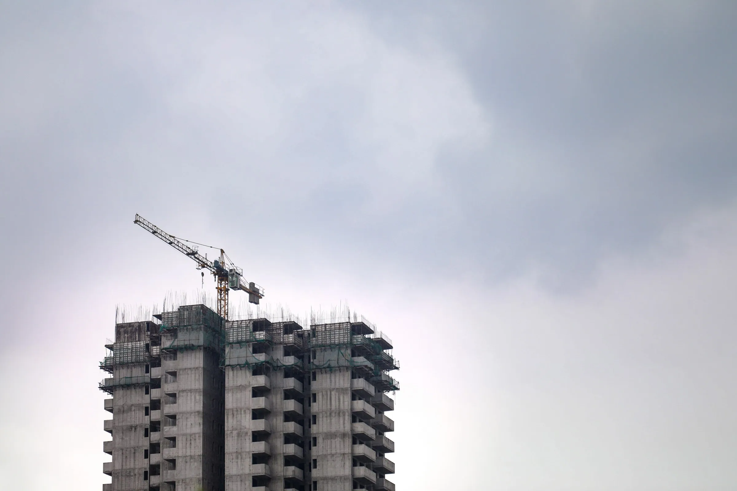 A tower crane above a high-rise under construction